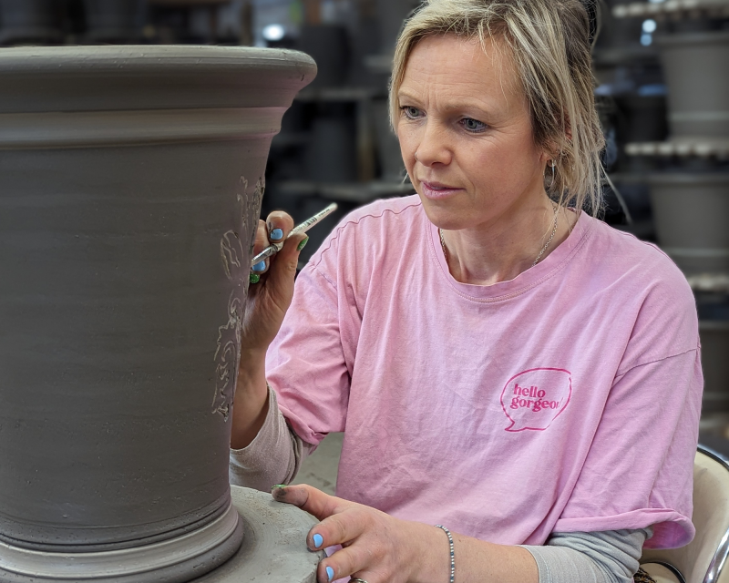 Emma decorating a flowerpot